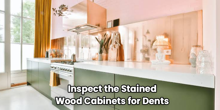 Inspect the Stained
Wood Cabinets for Dents