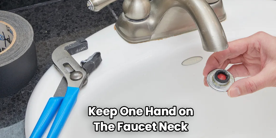 Keep One Hand on
The Faucet Neck