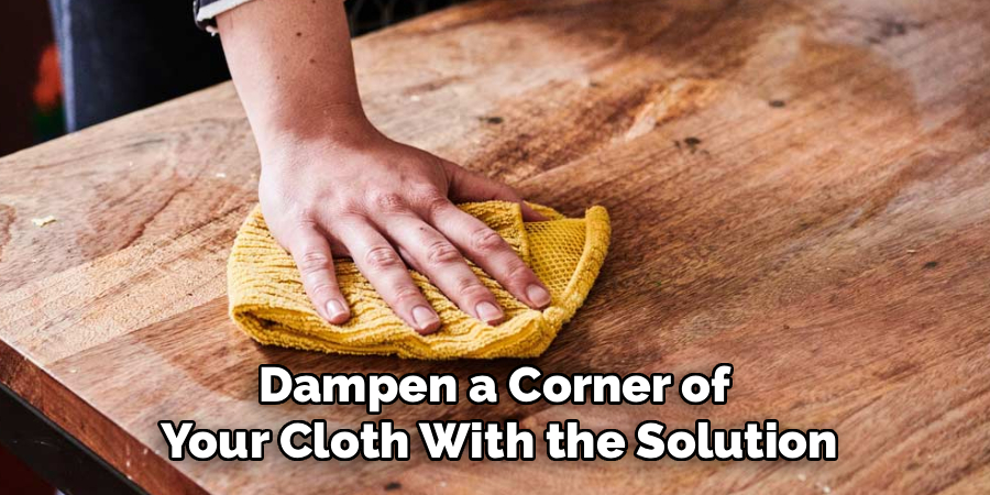 Dampen a Corner of 
Your Cloth With the Solution