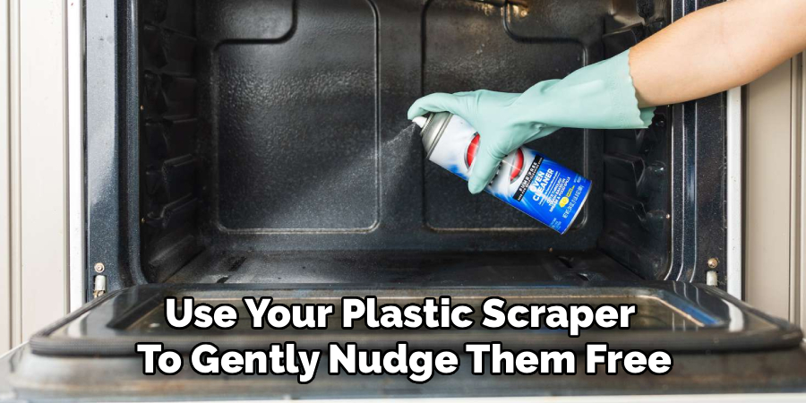 Use Your Plastic Scraper 
To Gently Nudge Them Free