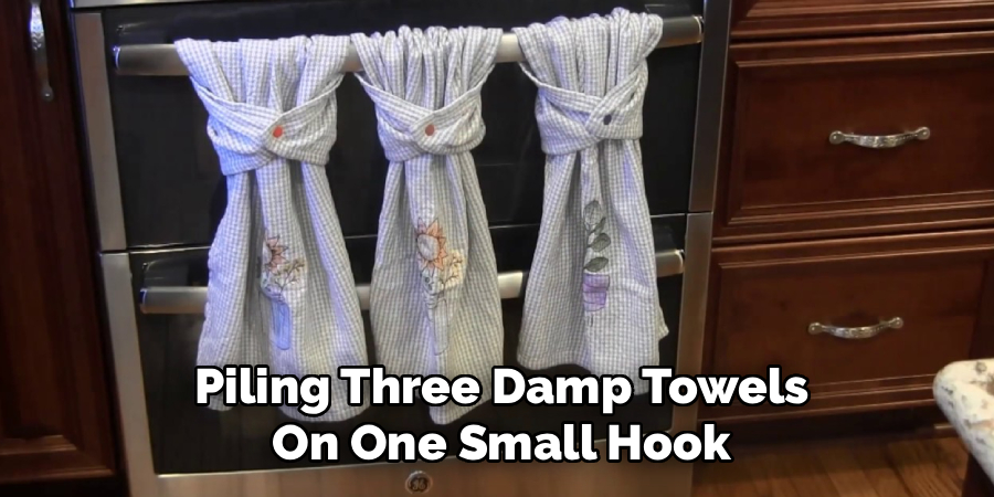 Piling Three Damp Towels
On One Small Hook